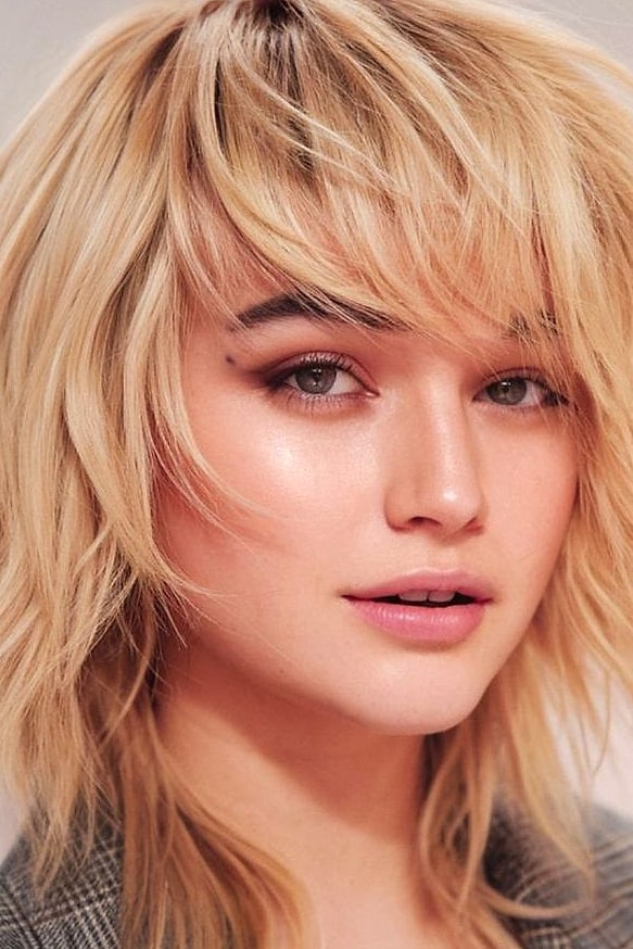 Wolf Cut With Bangs: 11 Ideas That Look So Good 5 Side-Swept Bangs With a Layered Wolf Cut