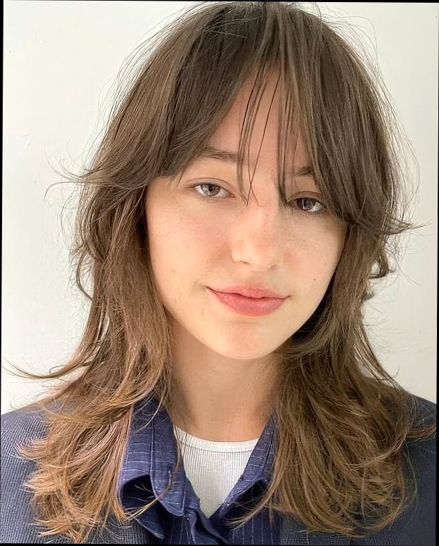 Wolf Cut With Bangs: 11 Ideas That Look So Good 4 Wispy Bangs With Soft Waves and a Wolf Cut