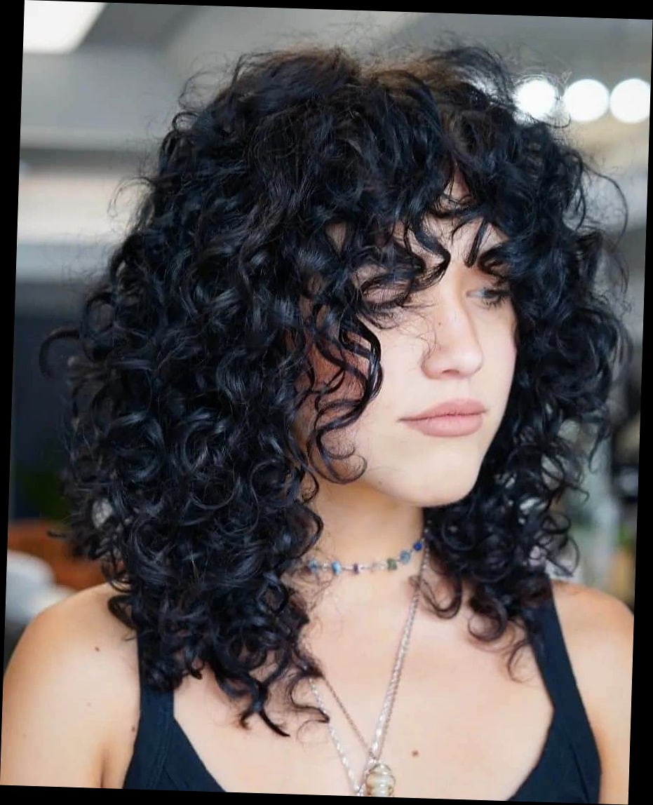 Wolf Cut With Bangs: 11 Ideas That Look So Good 9 Wolf Cut With Bangs on Curly Hair